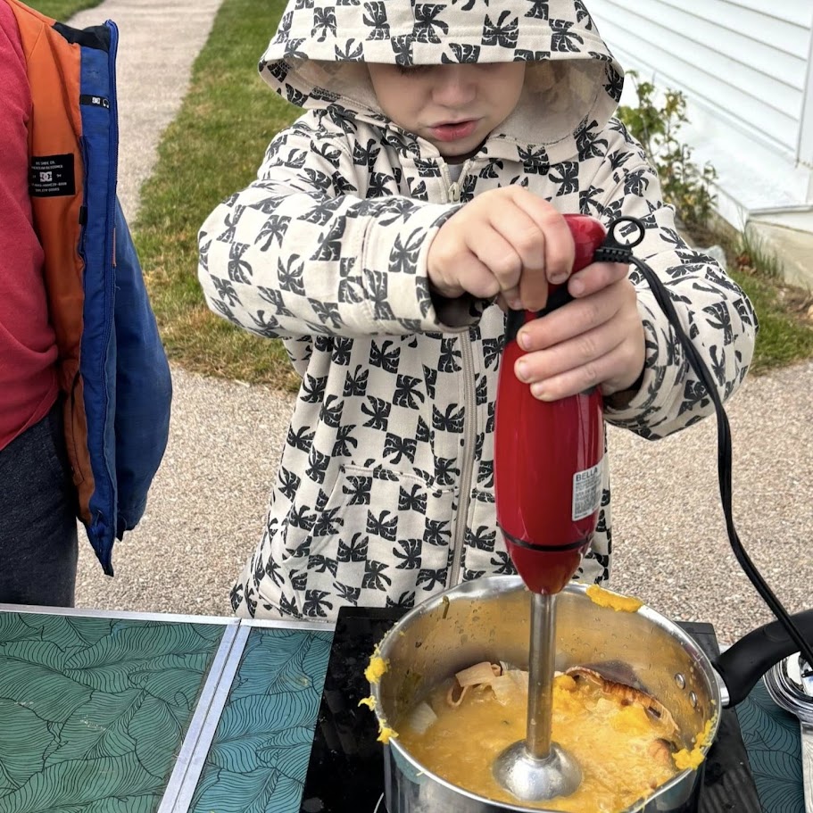 student mixing soup